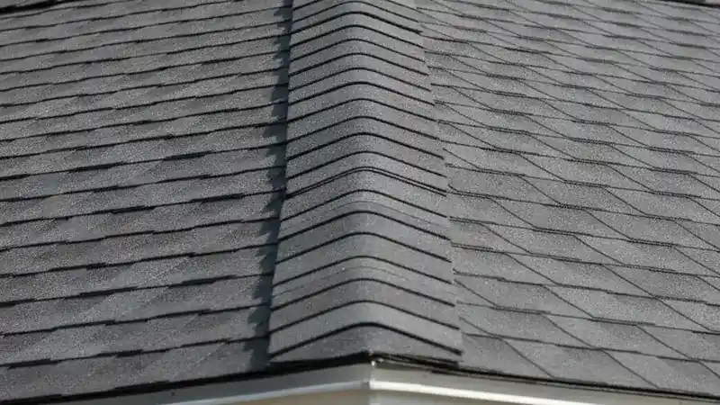 Close view of a newly finished roof ridge and clean shingle courses showing careful workmanship